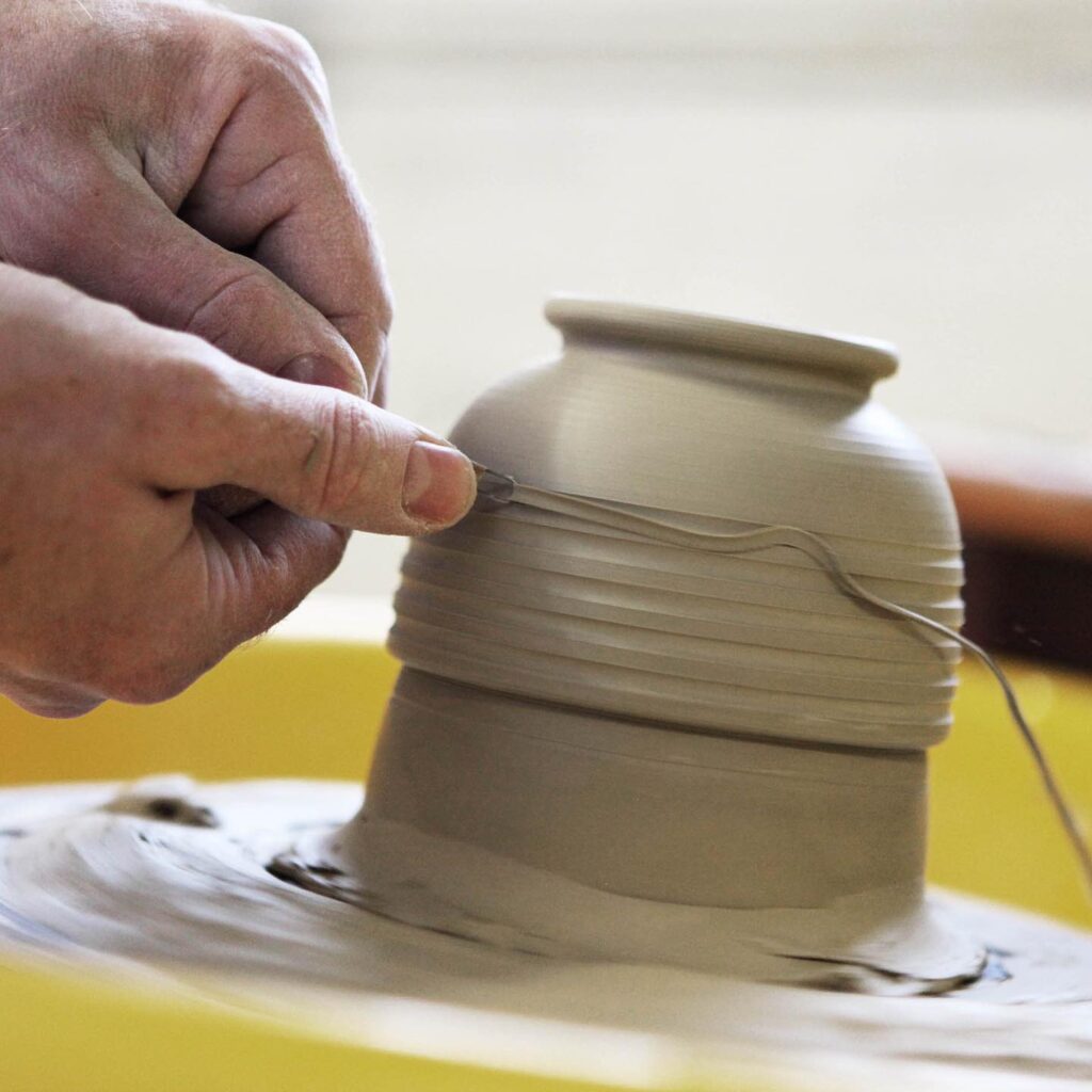 pottery being thrown on a wheel